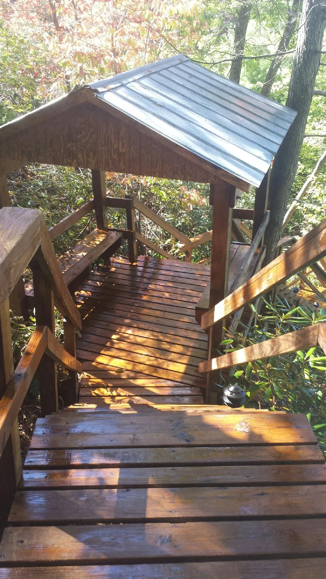Freshly stained wood walkway and covered shelter with a metal roof in Brodheadsville
