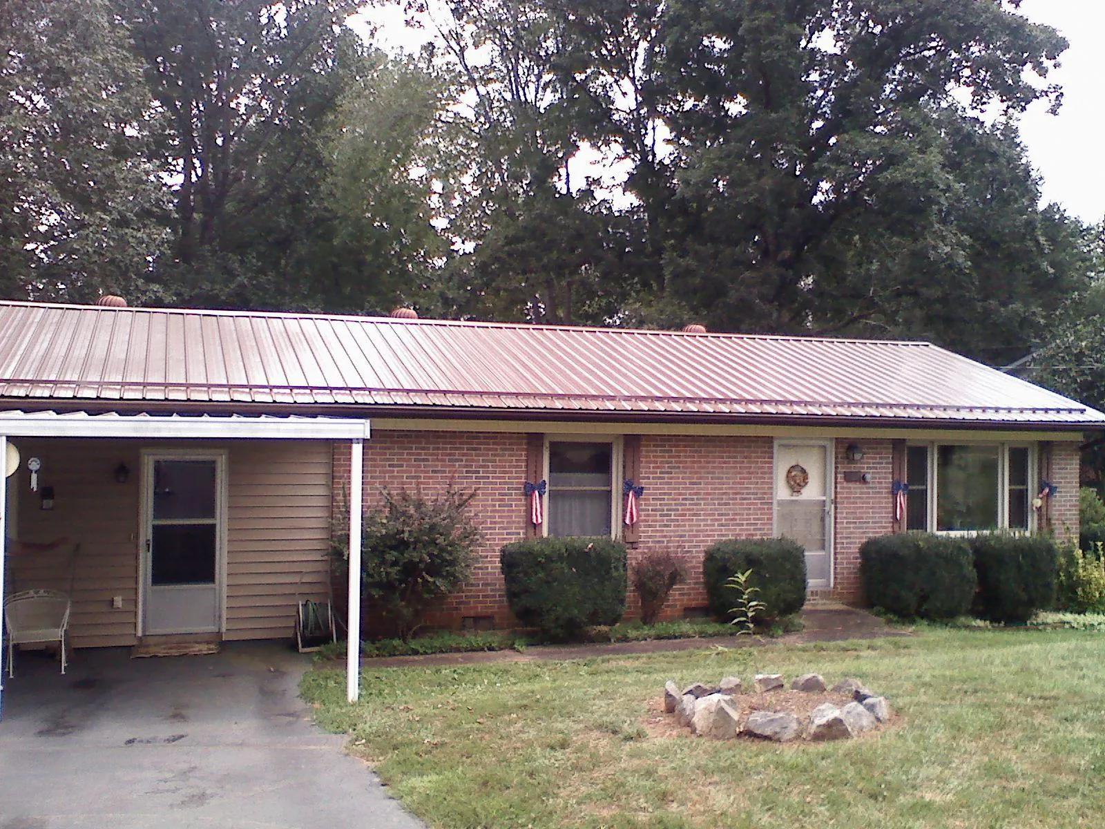 Bronze metal roof and carport on a brick ranch home — Roof Repair work by our crew in Brodheadsville